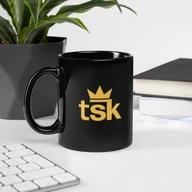 black mug — desk with plant and keyboard